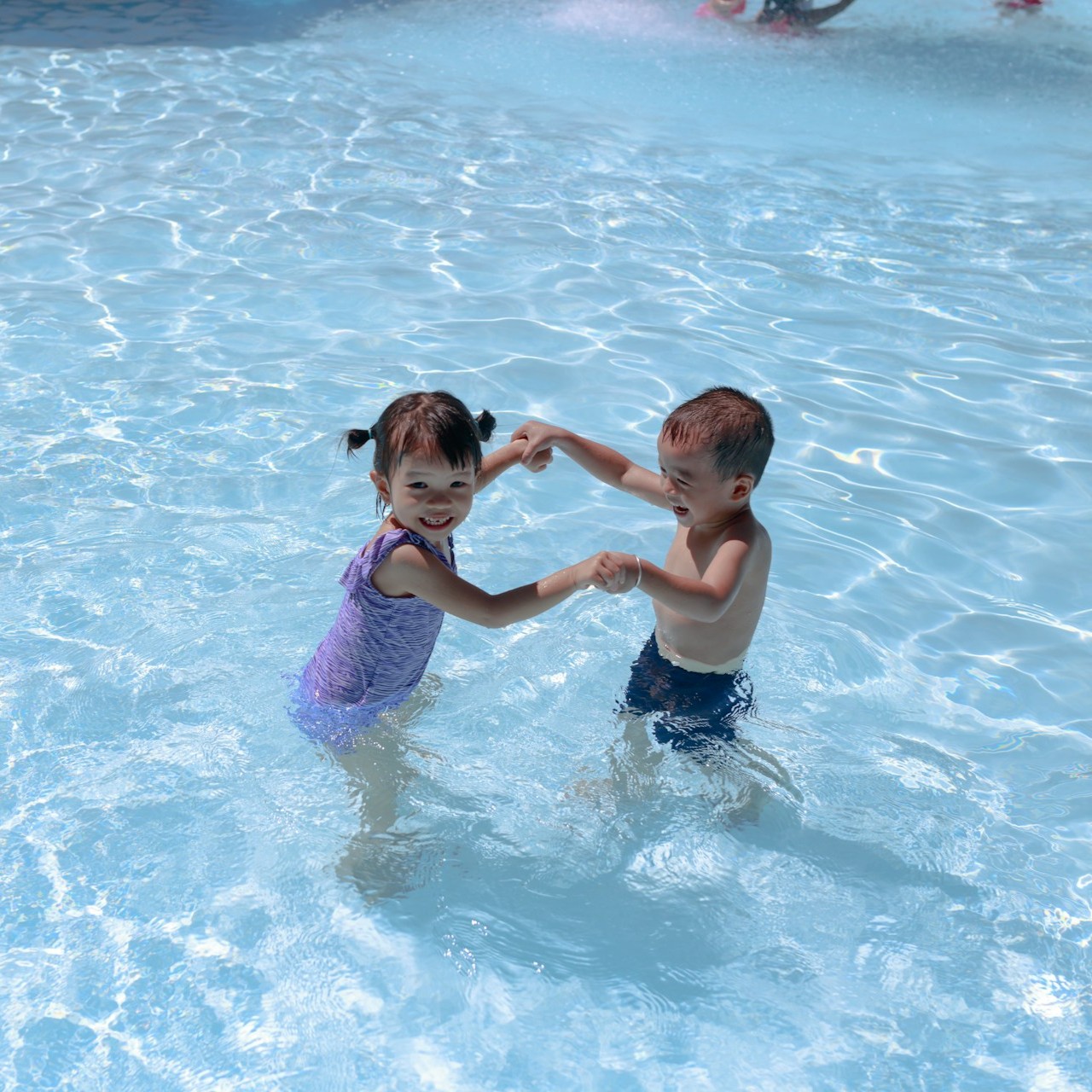 two-little-kids-playing-in-pool